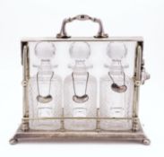 An early 20th century three bottle silver plated tantalus by Mappin & Webb,