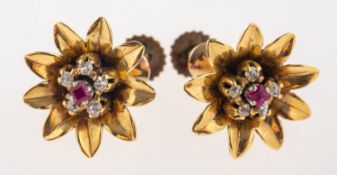 A pair of flowerhead screw back earrings, each set with a table-cut ruby,