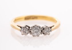 A three stone diamond ring, claw set with three brilliant-cut diamonds, marked 18ct & Plat,