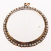 A seed pearl glazed locket, a circular locket with double sided glazed aperture,