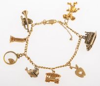 A charm bracelet with numerous charms, a figaro link bracelet, marked 14k, length approx. 17.