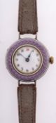 An Edwardian purple enamel and silver wristwatch the round dial with black Arabic numerals and red