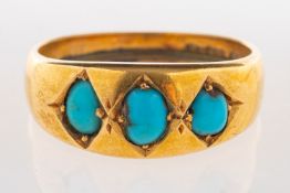 An antique turquoise ring, set with three turquoise cabochons,