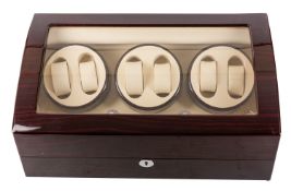 A wooden wristwatch display cabinet with automatic wind for six watches.