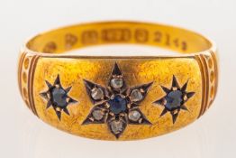 A 15ct gold Edwardian ring, star set with three circular-cut synthetic sapphires,