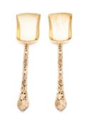 A pair of Victorian Pierced Vine pattern silver gilt serving spoons by Francis Higgins II,