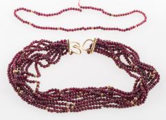 A twisted multi-strand garnet bead necklace,