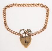 A 9ct gold graduated curb link bracelet, with heart padlock and safety chain, UK hallmark,