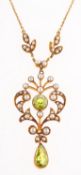 An Edwardian peridot and seed pearl necklace, the attached pendant of foliate design,