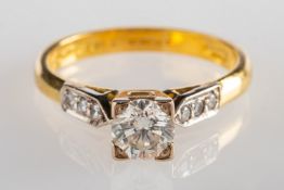 An 18ct gold diamond ring, square set to the centre with a brilliant-cut diamond, diamond approx. 0.