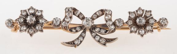A late Victorian brooch, of flowerhead and bow designed form, set with old-cut diamonds,