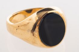 A 9ct gold and onyx signet ring, set with oval-cut black onyx, UK import mark, size T, 11.0grams.