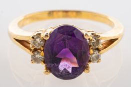 An amethyst and diamond ring, set to the centre with an oval-cut amethyst, amethyst approx. 2.