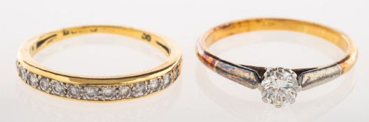 A group of two diamond rings, to include a solitaire ring set with a brilliant-cut diamond,