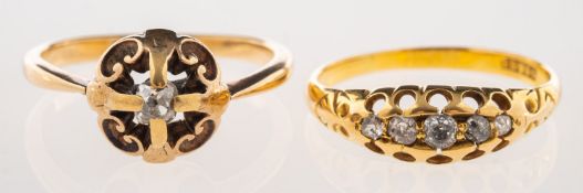 Two antique diamond rings, including an openwork scroll ring set with an old-cut diamond,