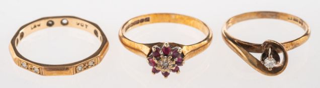 A group of three rings, including a 9ct gold twist ring set with a small brilliant-cut diamond,