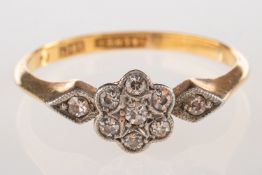 A vintage diamond daisy ring, in the form of a flowerhead and milgrain set with old-cut diamonds,