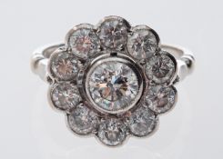 A diamond daisy ring, milgrain set with old brilliant-cut diamonds,