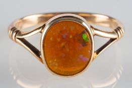An opal ring, collet set with an oval Ethiopian opal cabochon, measuring approx. 9.3mm x 7.8mm x 3.