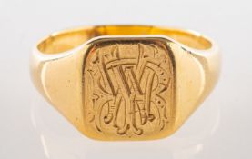 A signet ring, with engraved initials to front, unmarked, tests as 18ct, size S1/2, 7.8grams.