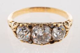A fine Victorian three stone diamond ring, set with old cushion-cut diamonds,