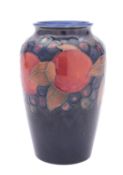 A Walter Moorcroft pottery vase of oviform, tube lined in the Pomegranate pattern on a blue ground,