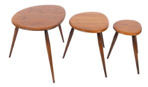 A nest of three Ercol elm and beech 'Pebble' tables,