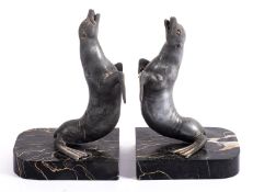 A pair of French spelter and marble mounted bookends modelled as seals,