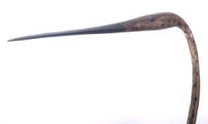 *Guy Taplin [b. 1939] Heron, a carved driftwood sculpture on metal rod and hardwood stand,