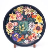 A Moorcroft pottery charger tube lined in the Carousel pattern after the original by Rachel Bishop,