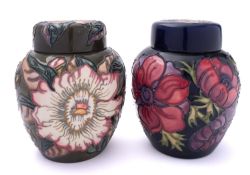 Two John Moorcroft pottery jars and covers,