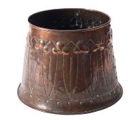 A repousse worked copper vessel in Arts & Crafts style, circa 1900; of circular section,