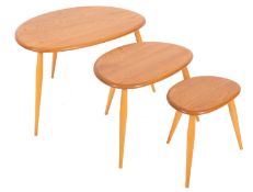 A nest of three Ercol elm and beech 'Pebble' tables,
