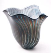 A cased art glass vase of flaring form with arbitrary rim the exterior with wrythen vertical bands