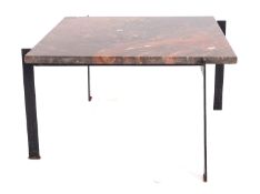 A minimalist wrought iron and marble topped coffee table,