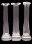 Patrick Stern [Contemporary] three clear glass vases with square base, fluted column and frill rim,