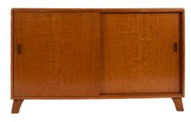 A light oak veneered sideboard, circa 1960s; the top with moulded edges, above twin sliding doors,