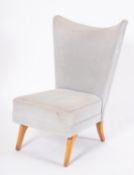 An upholstered wingback 'Encore' easy chair, probably by Howard Keith,
