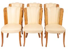 A walnut dining suite comprising table and six chairs, in Art Deco style,