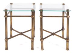 A pair of brass and glass occasional tables,