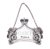 A silver wine label by Leslie Durbin, Lo