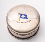A circular white metal and enamel box an