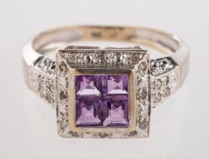 A 9ct white gold ring, set with four squ