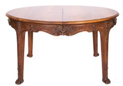 A Continental walnut oval dining table,