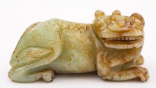 A Chinese jade figure of brown flecked c