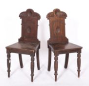 A pair of Victorian oak hall chairs, mid