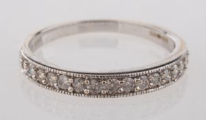 An 9ct white gold half eternity ring, mi