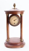 A mahogany domed portico mantel clock.