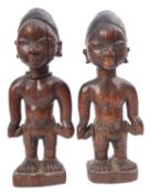 A pair of West African carved and partially ebonised models of twin boys, 'Ibeji', Yoruba people,