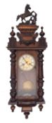 A Vienna-style German wall clock having an eight-day duration movement striking the hours and